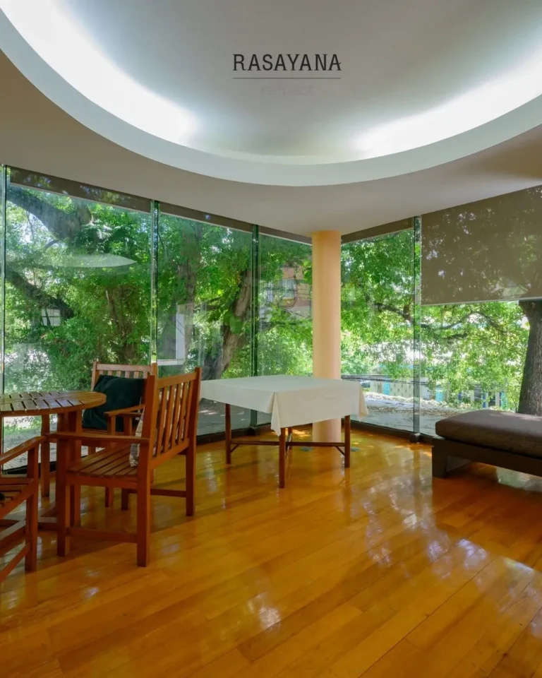 Bright meeting room surrounded by trees at Rasayana Retreat, Bangkok
