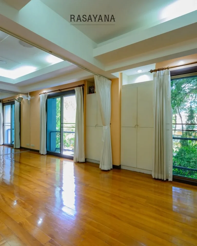 Studio hall with wooden floor for yoga classes and workshops at Rasayana Retreat, Bangkok